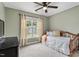 Bright bedroom with a daybed, black dresser, and outside views at 6901 Rex Rd, Holly Springs, NC 27540