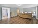 Bedroom with light-grey walls, hardwood floors, and connecting bathroom entrance at 6901 Rex Rd, Holly Springs, NC 27540