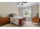 Cozy bedroom with natural light, floral curtains, and traditional wooden furniture at 6901 Rex Rd, Holly Springs, NC 27540