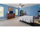 Spacious bedroom with blue walls, carpet floors, and natural light at 6901 Rex Rd, Holly Springs, NC 27540