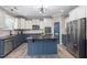 Beautiful kitchen featuring a central island, two-tone cabinets, and stainless steel appliances at 6901 Rex Rd, Holly Springs, NC 27540
