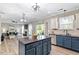 Open-concept kitchen showcasing a seamless transition to the living area, perfect for entertaining guests at 6901 Rex Rd, Holly Springs, NC 27540