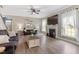 Bright living room featuring a fireplace, large windows with light curtains, and hardwood style floors at 6901 Rex Rd, Holly Springs, NC 27540