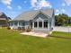 Spacious backyard with a sunroom, patio, and well-maintained lawn at 6965 Ogburn Farms Dr, Willow Springs, NC 27592