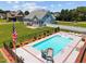 Beautiful backyard featuring an in-ground pool with a slide, a lawn, and mature trees at 6965 Ogburn Farms Dr, Willow Springs, NC 27592