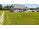 Large backyard with spacious lawn, fence, and enclosed sunroom at 6965 Ogburn Farms Dr, Willow Springs, NC 27592