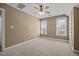 Bedroom with neutral carpet, fresh paint, ceiling fan, and two windows for ample natural light at 6965 Ogburn Farms Dr, Willow Springs, NC 27592