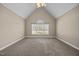 Large carpeted bedroom featuring a vaulted ceiling, ceiling fan, and window with blinds at 6965 Ogburn Farms Dr, Willow Springs, NC 27592