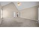 Spacious carpeted bedroom featuring vaulted ceiling, fan and two doorways in view at 6965 Ogburn Farms Dr, Willow Springs, NC 27592