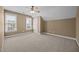 Bright bedroom with neutral carpet, natural light from two windows, and ample closet space at 6965 Ogburn Farms Dr, Willow Springs, NC 27592