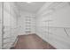 Walk-in closet offering ample storage space with wire shelving and neutral carpeting at 6965 Ogburn Farms Dr, Willow Springs, NC 27592
