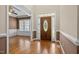 Elegant foyer with hardwood floors, decorative front door, and view into adjacent living space at 6965 Ogburn Farms Dr, Willow Springs, NC 27592