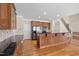 Open kitchen with stainless steel appliances, wood cabinetry, and a large island with a breakfast bar at 6965 Ogburn Farms Dr, Willow Springs, NC 27592