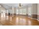 Bright living room featuring a fireplace, large windows, and hardwood floors at 6965 Ogburn Farms Dr, Willow Springs, NC 27592