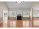 Bright living room with hardwood floors, fireplace, and sunroom access at 6965 Ogburn Farms Dr, Willow Springs, NC 27592