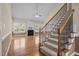 Bright living room featuring a fireplace, staircase, hardwood floors, and plenty of natural light at 6965 Ogburn Farms Dr, Willow Springs, NC 27592