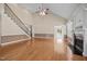 Vaulted living room with stairs, fireplace, natural light, and hardwood floors at 6965 Ogburn Farms Dr, Willow Springs, NC 27592