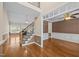 Open-concept living space with hardwood floors, staircase, and view into the adjacent dining room at 6965 Ogburn Farms Dr, Willow Springs, NC 27592