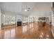 Open living room featuring hardwood floors, fireplace, natural light, and vaulted ceilings at 6965 Ogburn Farms Dr, Willow Springs, NC 27592