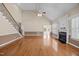 Vaulted ceiling living room showcasing a fireplace, staircase, hardwood floors and natural light at 6965 Ogburn Farms Dr, Willow Springs, NC 27592