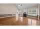 Living room with hardwood floors, a fireplace, and large windows at 6965 Ogburn Farms Dr, Willow Springs, NC 27592