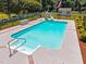 In-ground pool with a slide, seating, and beautiful landscaping at 6965 Ogburn Farms Dr, Willow Springs, NC 27592
