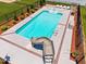Aerial shot of the pool area including a slide, landscaping, and lounge furniture at 6965 Ogburn Farms Dr, Willow Springs, NC 27592