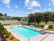Backyard pool and patio area surrounded by a fence, landscaping, and mature trees at 6965 Ogburn Farms Dr, Willow Springs, NC 27592