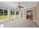 Bright sunroom with ceiling fan, large windows and access to backyard through glass paned doors at 6965 Ogburn Farms Dr, Willow Springs, NC 27592