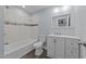 Stylish bathroom with white tiled shower, modern vanity, and updated fixtures at 703 Whitsett Ave, Gibsonville, NC 27249