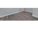 This bedroom has hardwood flooring, with base molding and neutral color at 703 Whitsett Ave, Gibsonville, NC 27249