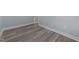 This bedroom has hardwood flooring, with base molding and neutral color at 703 Whitsett Ave, Gibsonville, NC 27249