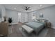 Bright bedroom with ceiling fan, hardwood floors, and a large window at 703 Whitsett Ave, Gibsonville, NC 27249