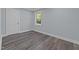 This bedroom features a window that provides natural light and hardwood flooring at 703 Whitsett Ave, Gibsonville, NC 27249