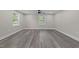 The bedroom features hardwood floors, natural light from two windows, and a ceiling fan at 703 Whitsett Ave, Gibsonville, NC 27249