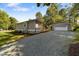 Charming single-story home with gray siding, stone accents, and a detached two-car garage at 703 Whitsett Ave, Gibsonville, NC 27249