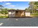 Inviting home featuring a covered porch with wood railings and gray siding, offering a cozy outdoor space at 703 Whitsett Ave, Gibsonville, NC 27249