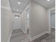 Hallway with modern flooring leading to the front door and bathroom at 703 Whitsett Ave, Gibsonville, NC 27249