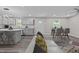 Open concept living and dining area with modern furnishings and hardwood flooring at 703 Whitsett Ave, Gibsonville, NC 27249