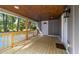The porch features a wooden railing, and a ceiling with recessed lighting at 703 Whitsett Ave, Gibsonville, NC 27249