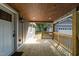 The porch features wooden flooring and a wooden railing with recessed lighting at 703 Whitsett Ave, Gibsonville, NC 27249