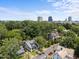 Scenic aerial view of a residential neighborhood with mature trees and city skyline at 708 Parker St, Durham, NC 27701