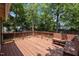 Relax on this wooden back deck with shade trees and wooden bench at 708 Parker St, Durham, NC 27701