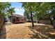 Large backyard space with shade trees and mulch, complemented by a wooden deck at 708 Parker St, Durham, NC 27701