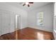 Bedroom with hardwood floors, ceiling fan, large window and a walk in closet at 708 Parker St, Durham, NC 27701