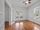Bright bedroom with hardwood floors, ample natural light, and french door at 708 Parker St, Durham, NC 27701