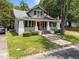 Charming craftsman home featuring a covered front porch with red shutters and brick-lined steps at 708 Parker St, Durham, NC 27701