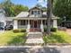 Charming craftsman home featuring a covered front porch with red shutters and brick-lined steps at 708 Parker St, Durham, NC 27701