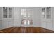 Charming living room featuring hardwood floors, built-in cabinets, and glass paneled french doors at 708 Parker St, Durham, NC 27701