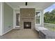 Relaxing back porch with brick fireplace, neutral paint scheme, and porch swing at 733 Daniel Ridge Rd, Wendell, NC 27591